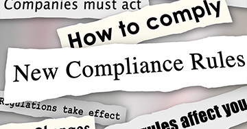 Headlines ripped from a newspaper that read new compliance rules