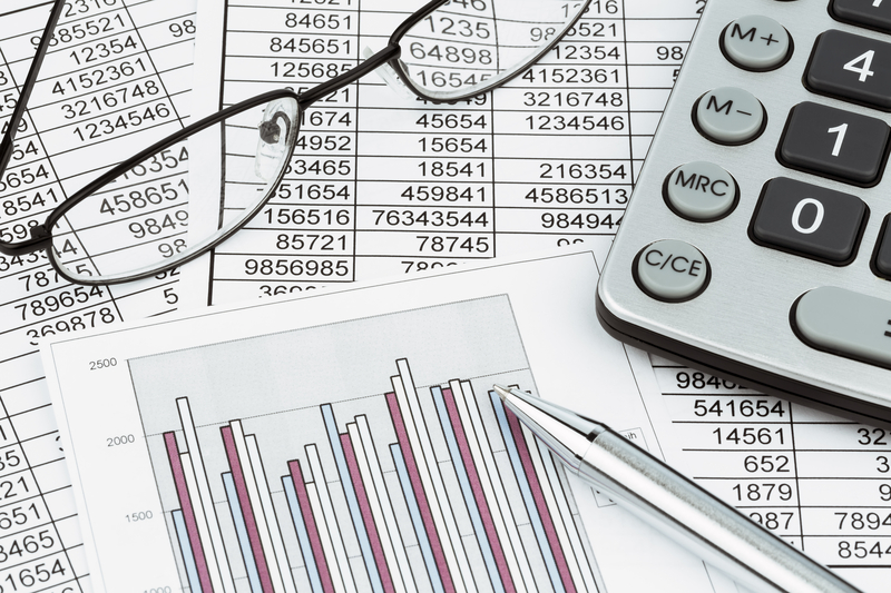 Financial reports with glasses and a calculator