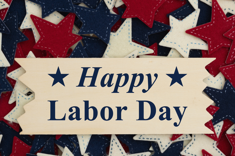 A board with red, white, and blue stars stating Happy Labor Day