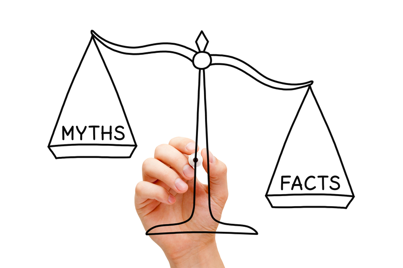 Hand drawing Facts Myths scale concept with black marker on transparent wipe board isolated on white.