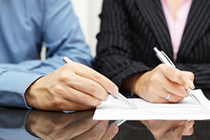 A picture of two people reviewing a document