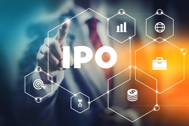 Business man reaching towards a sign saying IPO