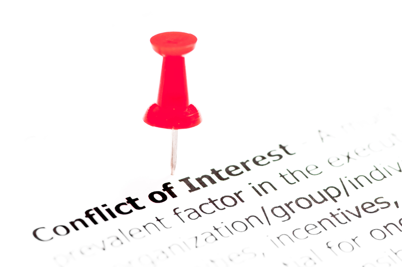 A red pushpin tacked near the words Conflict of Interest